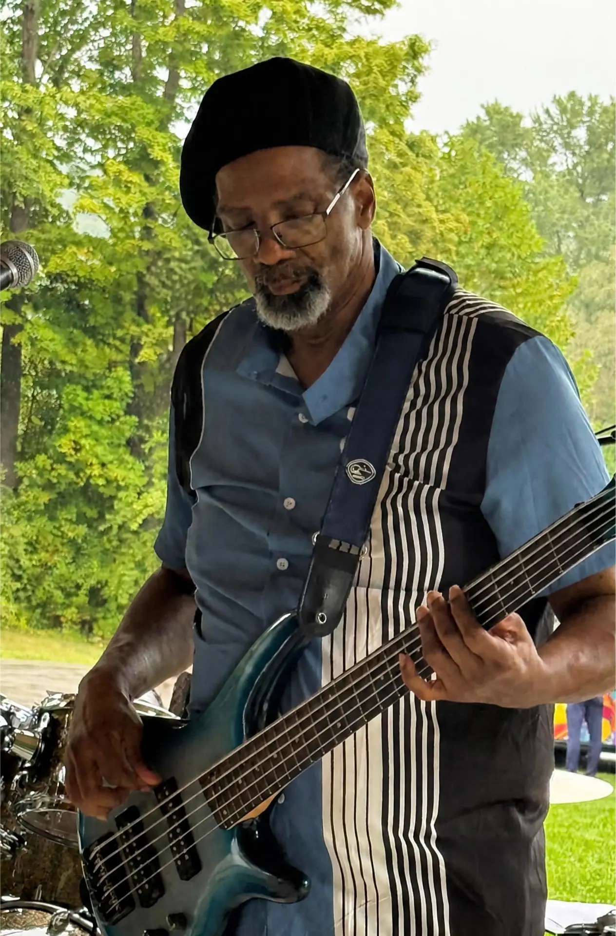 Curt Strawder playing his blue bass guitar live