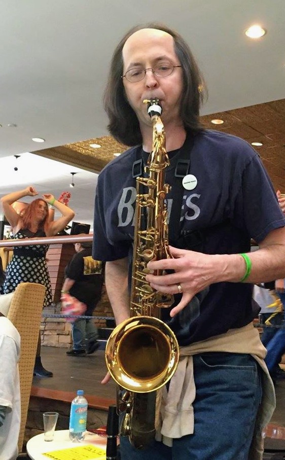 Blue Cadillac Band saxophonist playing alto sax live